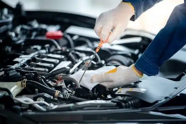 an imafge of a mechanic checking the car mobil oil