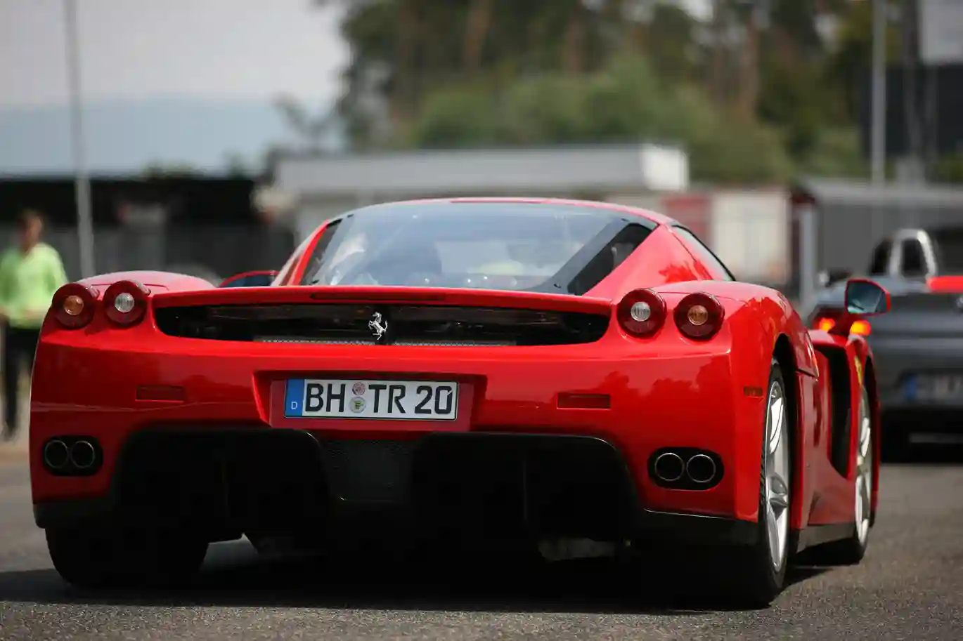 an image of a Ferrari from its back side, which doens not look like cheap cars