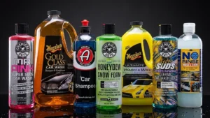 Seven bottles of car wash soap lined up on a dark reflective surface