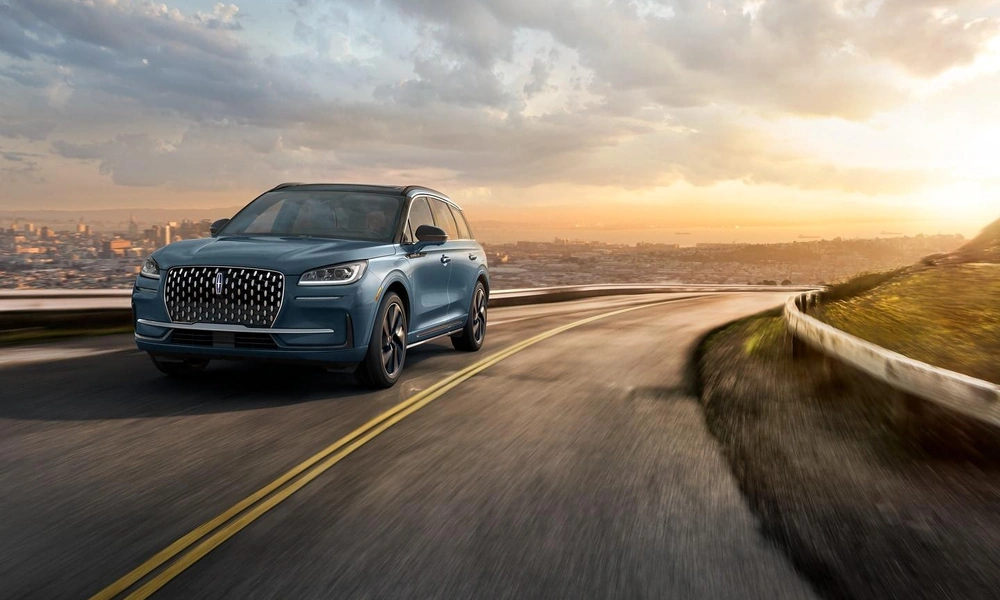 Blue Lincoln Corsair compact luxury SUV parked on a scenic road.