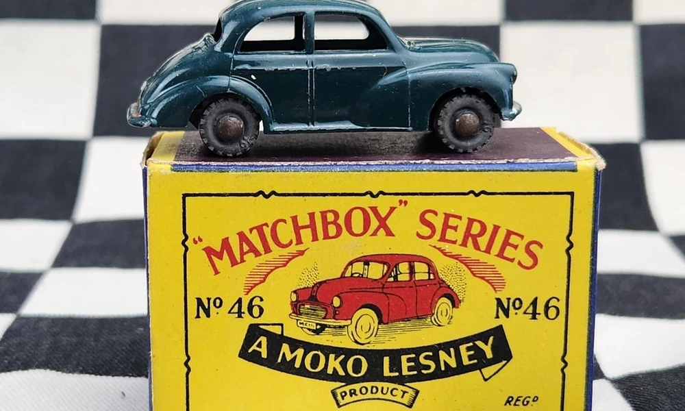 Vintage Matchbox die-cast car beside its original-style cardboard box.