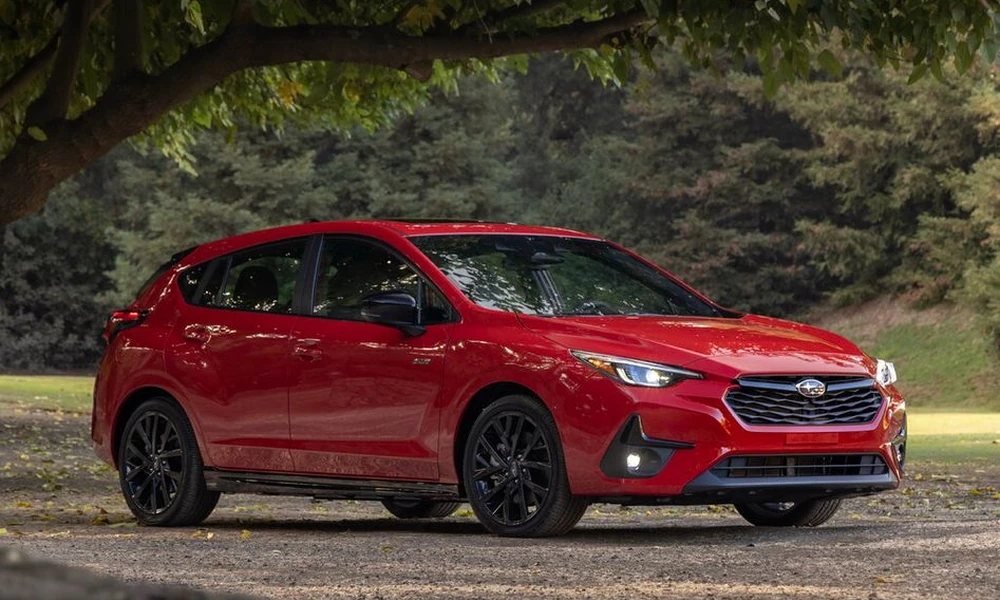 Red Subaru Impreza hatchback parked under a tree