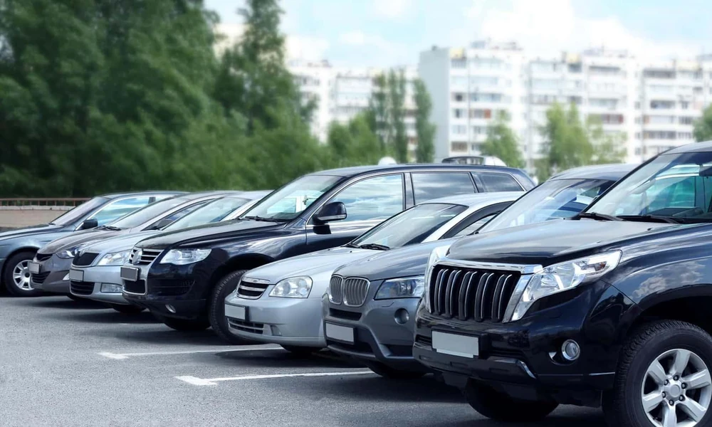Used sedans, SUVs, and pickup trucks parked in a car lot.