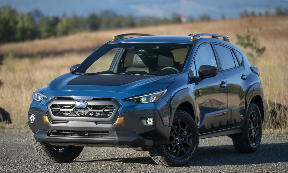 Blue Subaru Crosstrek compact crossover parked on a gravel road