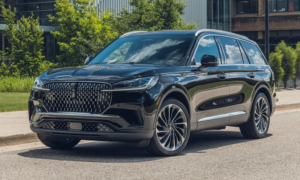 Black Lincoln Aviator three-row luxury SUV outside a modern building.