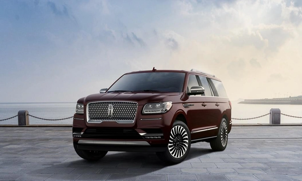 Dark burgundy Lincoln Navigator full-size luxury SUV parked on a driveway.