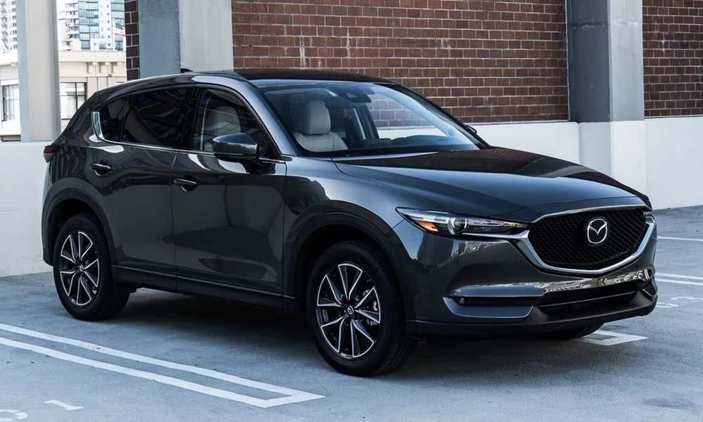 Gray Mazda CX-5 parked beside a brick building