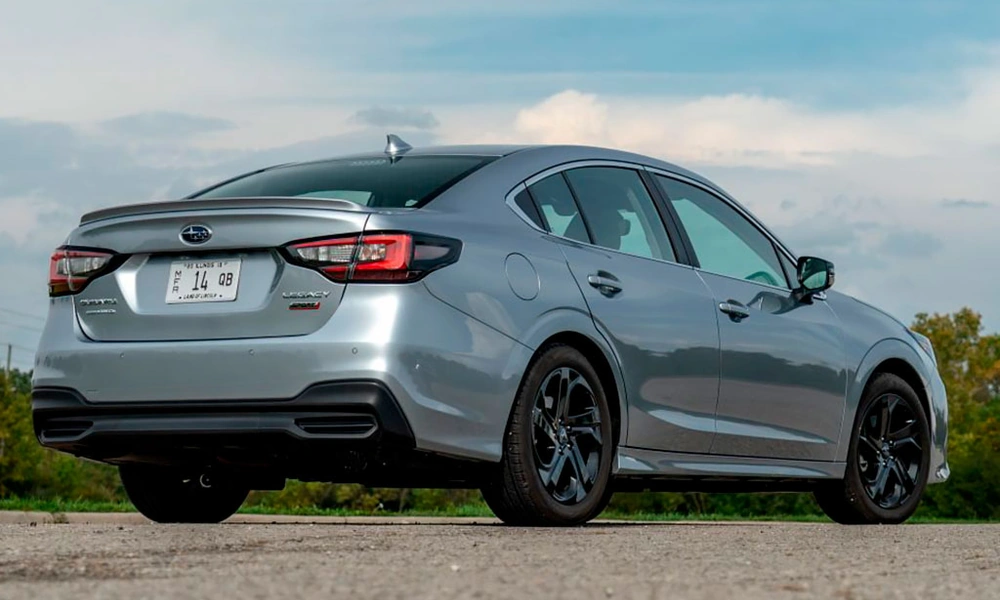 Rear three-quarter view of a silver Subaru Legacy midsize sedan
