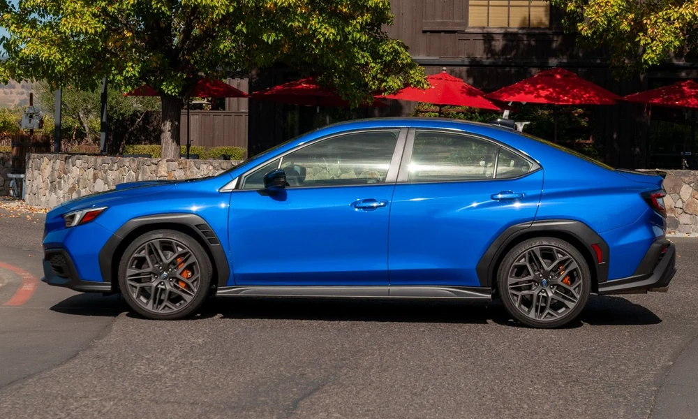 Side view of a blue Subaru WRX sports sedan