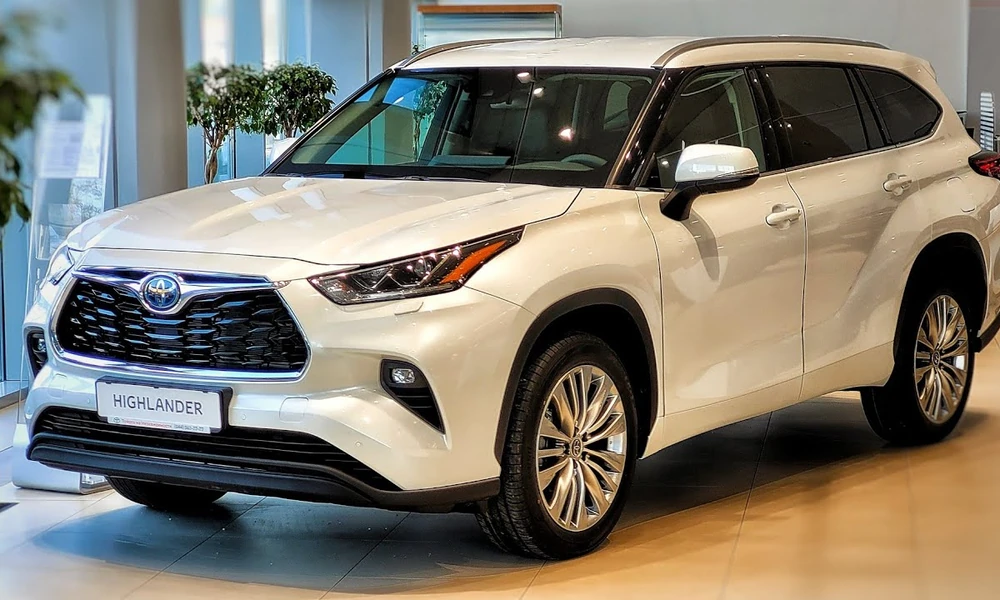 White Toyota Highlander Hybrid parked in a showroom