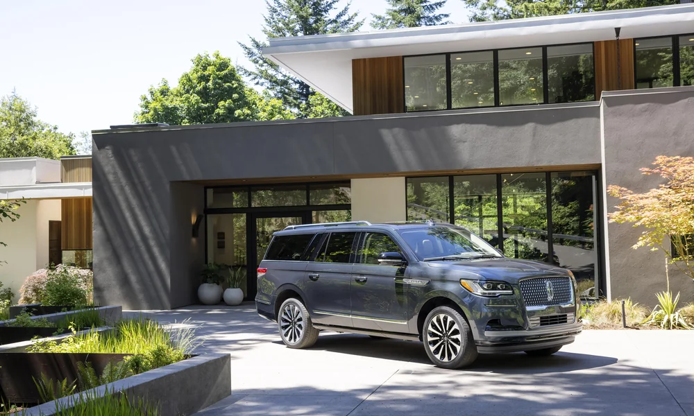 Lincoln luxury SUV parked in the driveway of a modern family home.