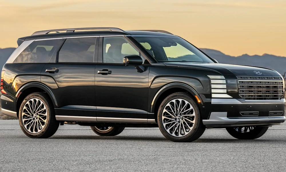 Black Hyundai Palisade parked in front of distant mountains at sunset