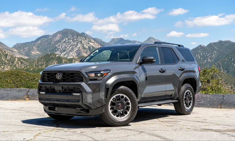 Gray Toyota 4Runner parked with rocky mountains in the background