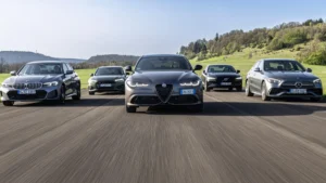 Modern sedan cars parked on a scenic road showing their elegant exterior designs.