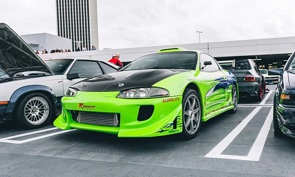 Green modified Mitsubishi Eclipse sports coupe.