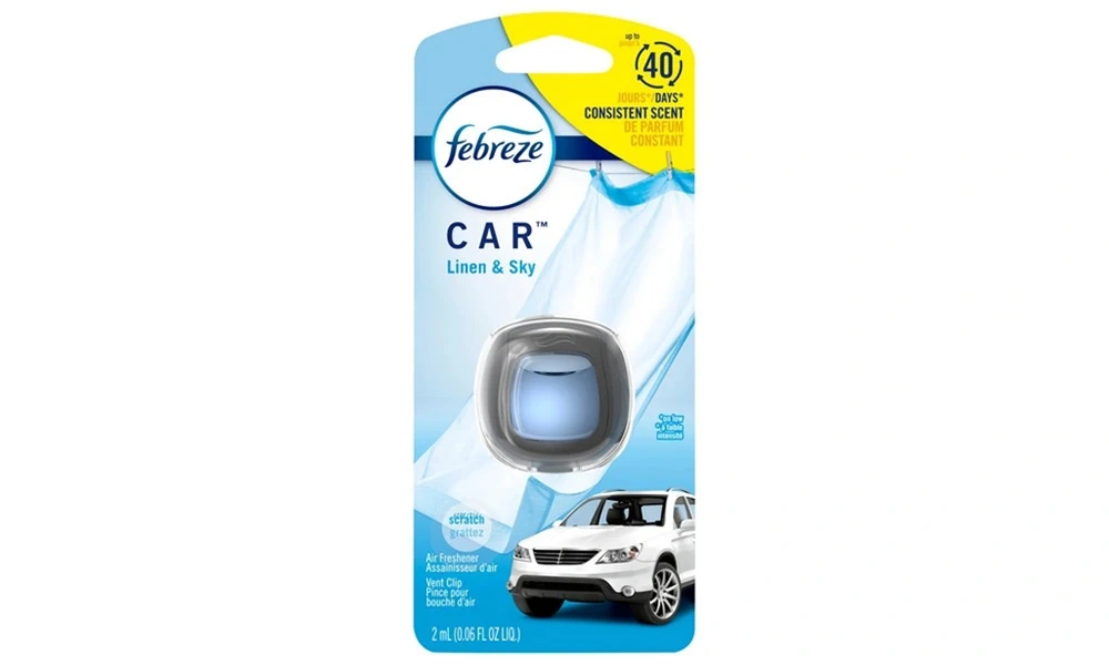 Febreze CAR Linen & Sky vent clip air freshener in blister packaging with a white SUV