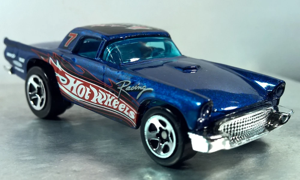 Blue Hot Wheels 1957 Thunderbird die-cast car with racing flame graphics and number 7