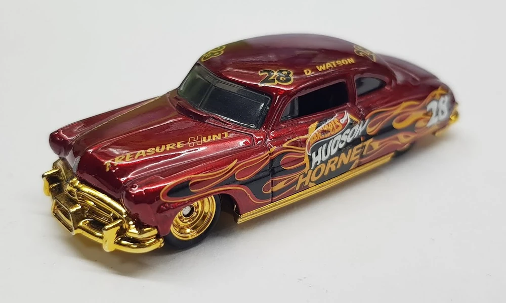 Red Hot Wheels Hudson Hornet Treasure Hunt car with gold chrome trim and flame graphics