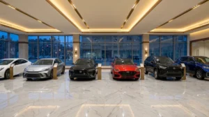 Row of hybrid cars on display in a bright showroom with large windows