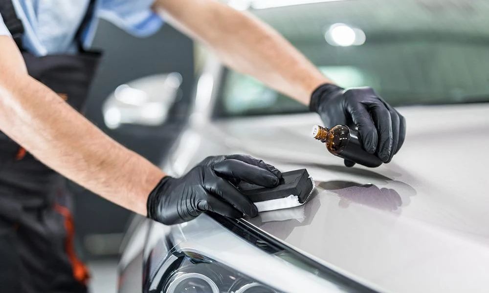 Automotive ceramic coating being applied to a car's exterior paint.