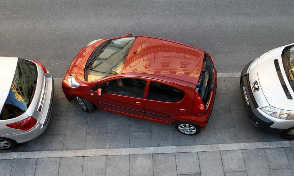Small hatchback parked on a narrow urban street
