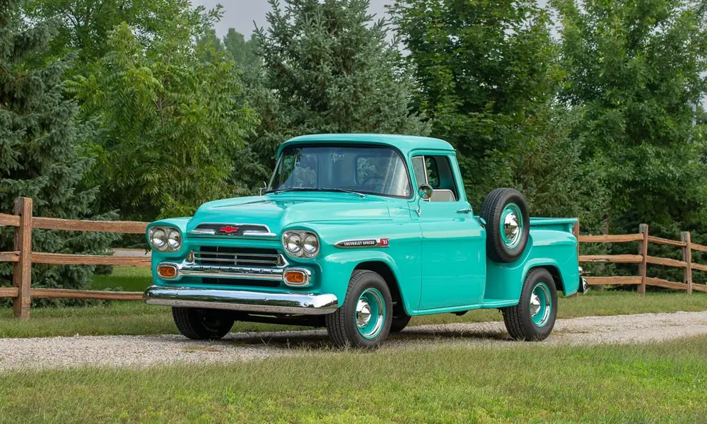 Restored vintage American pickup trucks parked outdoors.