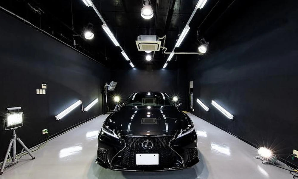 Ceramic-coated car inside a detailing studio during the curing process.