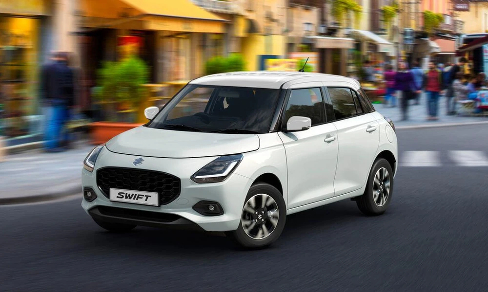 Suzuki Swift compact hatchback driving in the city