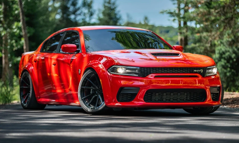 : Red Dodge Charger showing its muscular exterior design and front grille.