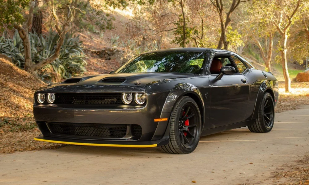 Black Dodge Challenger muscle car with distinctive front grille and aggressive styling.
