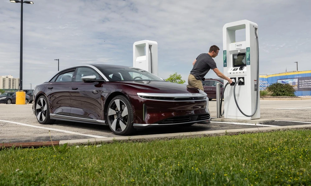 Lucid Air electric sedan connected to a DC fast charging station.