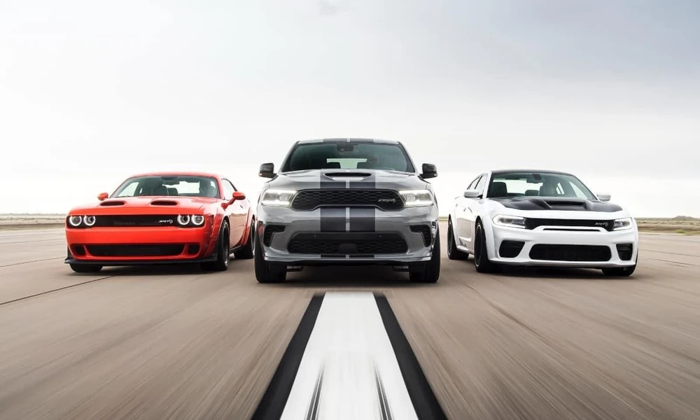 Dodge Charger and Durango displayed in an automotive dealership showroom.