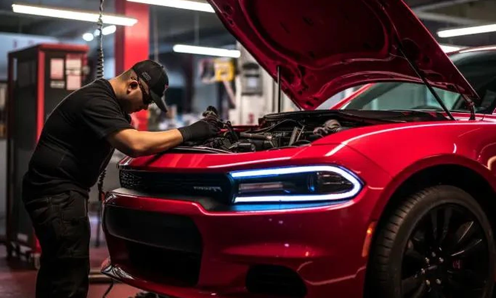 Mechanic inspecting a used Dodge Charger before a vehicle purchase.