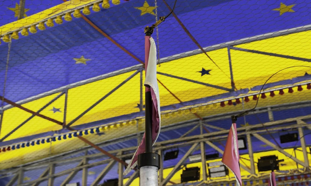 Overhead electrical grid and metal contact poles used in traditional bumper car systems.