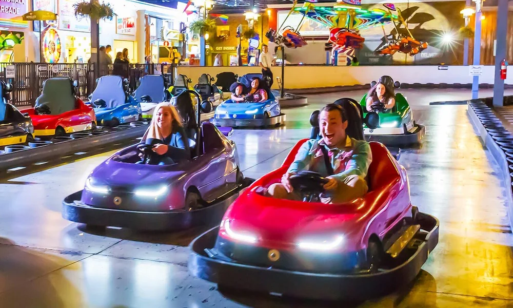 Battery-powered electric bumper cars inside an indoor entertainment facility.