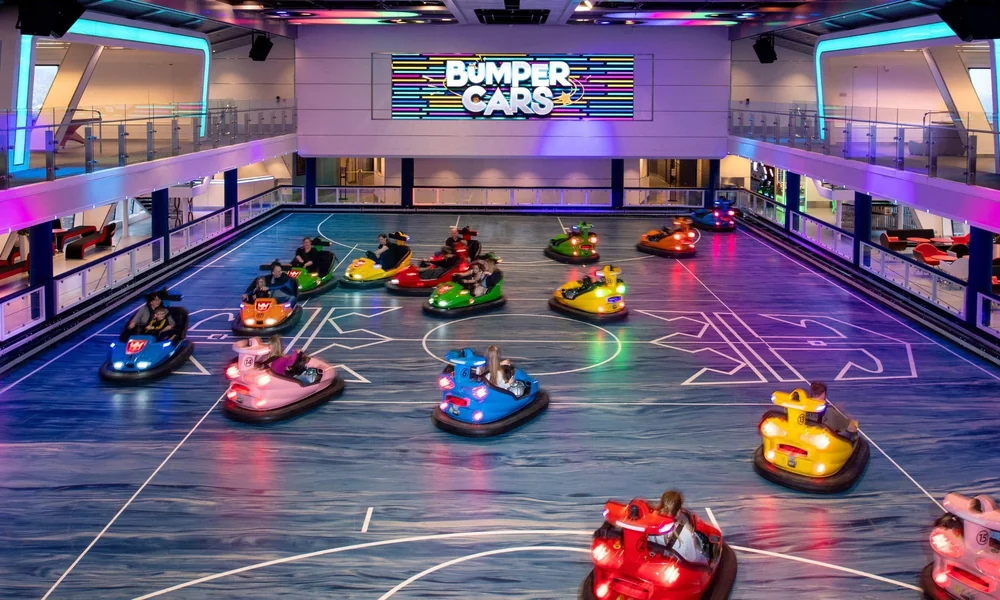Indoor bumper car arena showing its driving floor, safety barriers, and riding area.