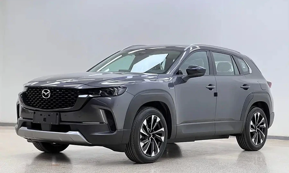 Gray Mazda CX-50 compact SUV in a bright studio
