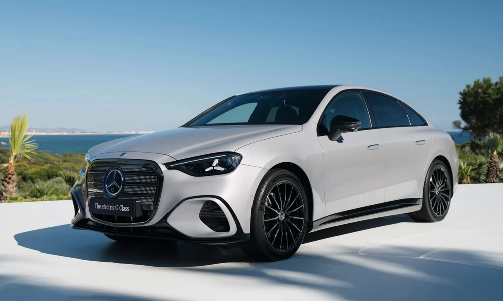 Silver Mercedes-Benz electric C-Class sedan parked by the sea under a clear sky