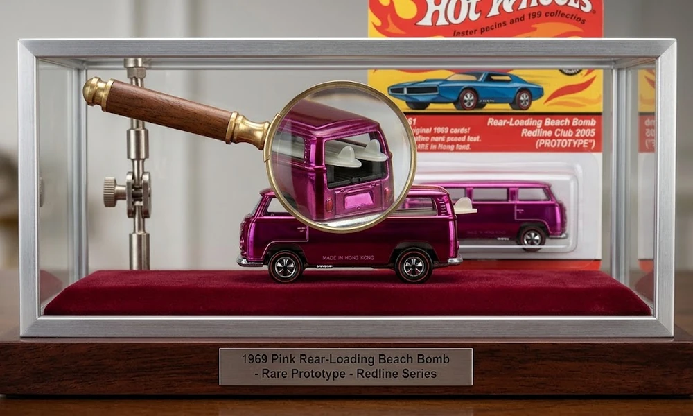 Pink 1969 Rear-Loading Beach Bomb Hot Wheels prototype in a display case with magnifying glass