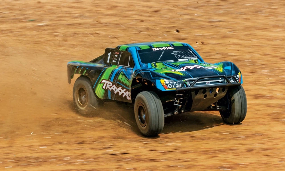 Traxxas Slash short-course RC truck driving on a dirt track