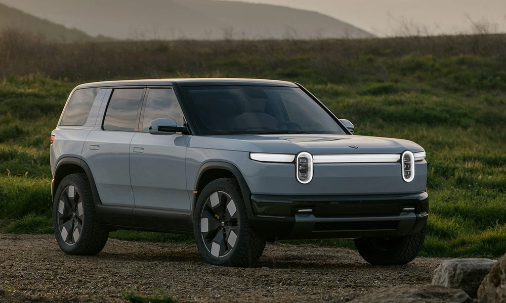 Rivian R2 electric SUV shown in an outdoor setting.