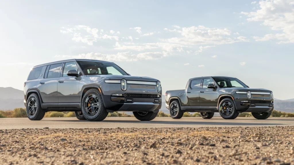 Rivian R1T electric pickup truck and R1S electric SUV parked outdoors.