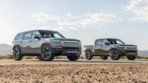 Rivian R1T electric pickup truck and R1S electric SUV parked outdoors.