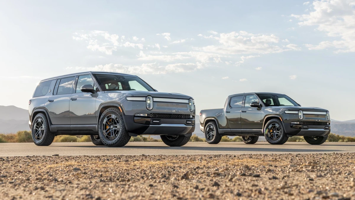Rivian R1T electric pickup truck and R1S electric SUV parked outdoors.