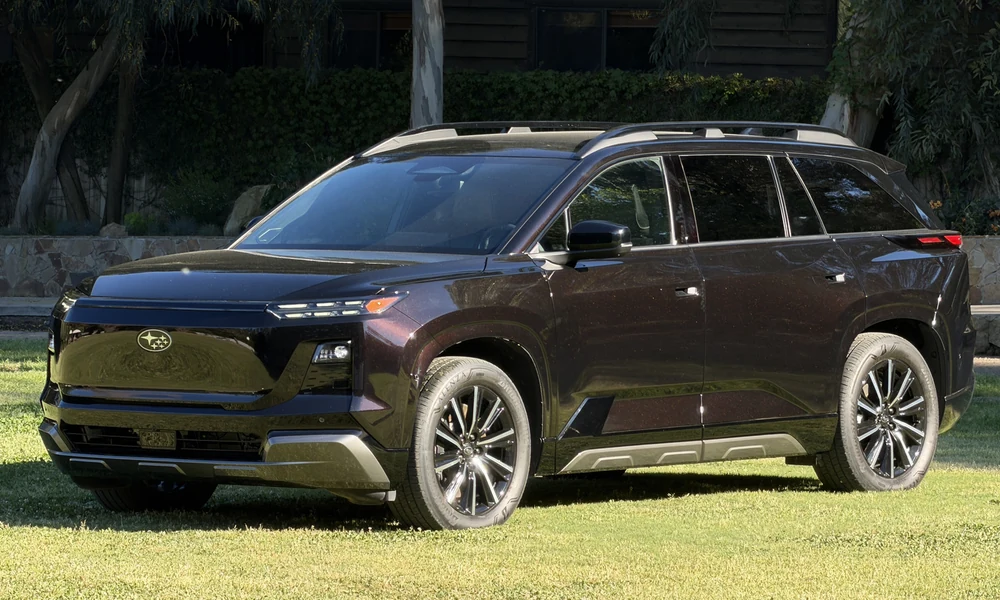 Dark Subaru Getaway electric SUV parked on a lawn with trees behind it