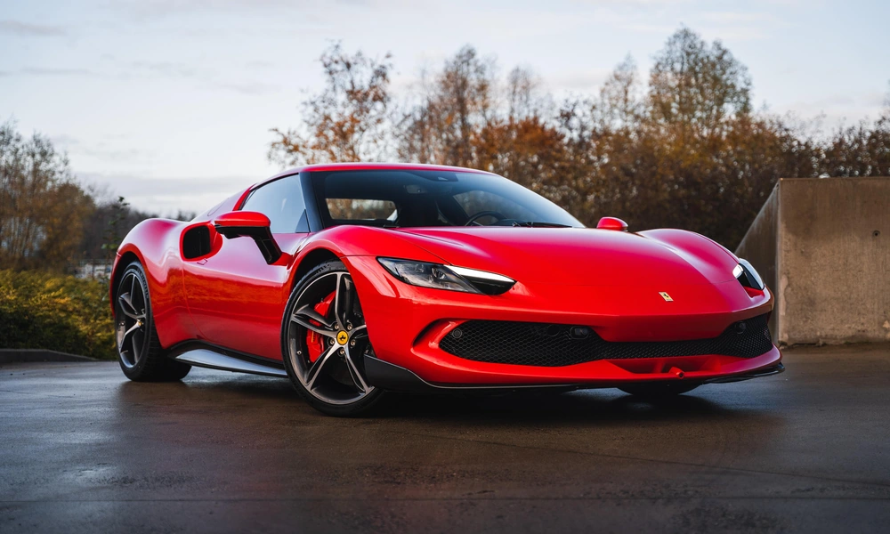 Red high-performance supercar photographed on a mountain road.