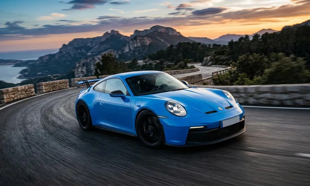 Blue Porsche 911 GT3 RS with a prominent rear wing.