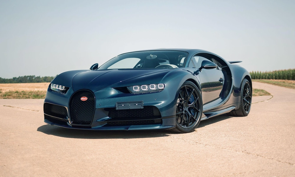 Blue and black Bugatti Chiron parked outdoors.