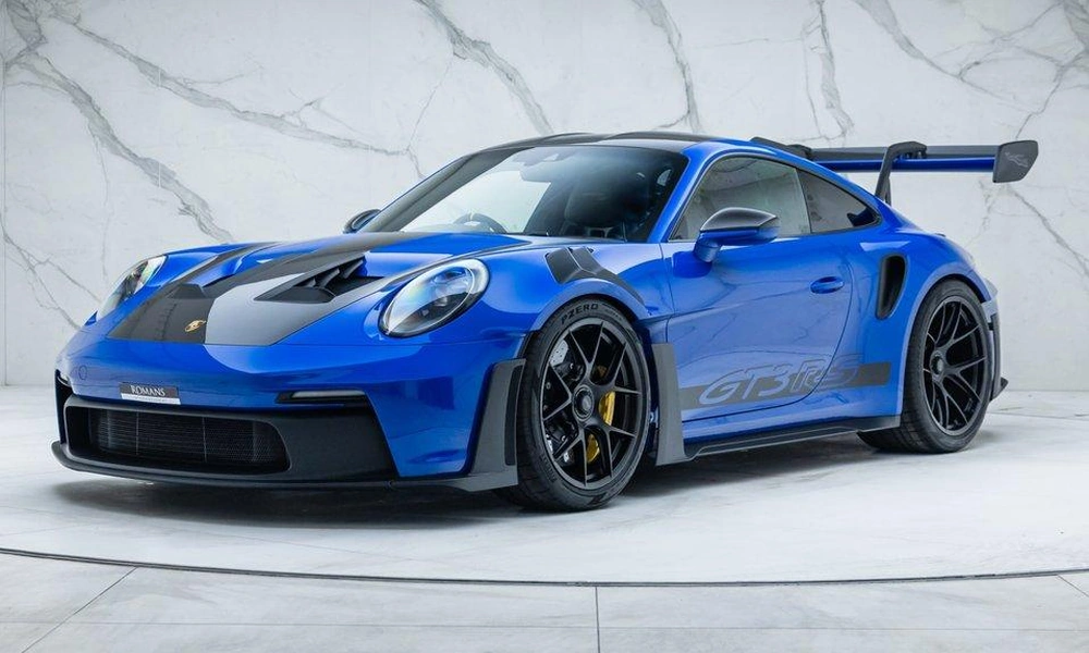 Blue Porsche 911 GT3 RS with aerodynamic bodywork.