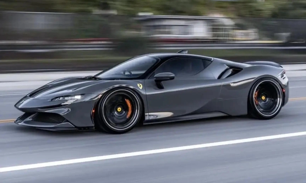 Grey supercar driving on a city street.